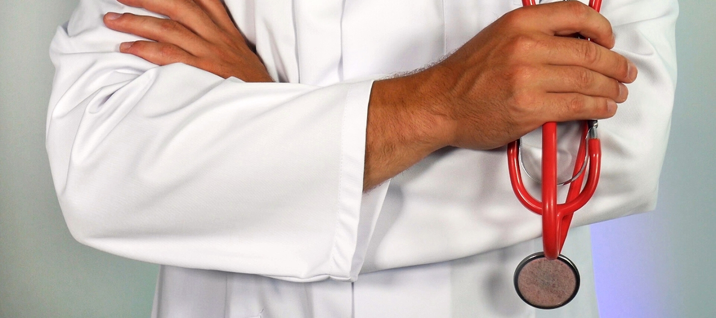 Doctor with crossed arms holding a stethoscope